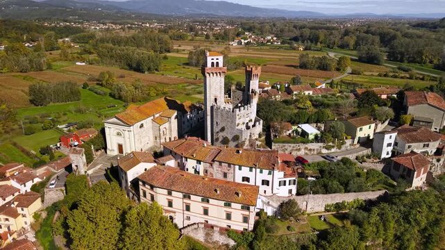 Nozzano Castle Lucca Tuscany Aerial Drone View Medieval Borgo Cinematic Orbit Flight Traditional Walled Fortress and Authentic Tuscan Countryside Landscape Travel Destination Italy 4K UHD