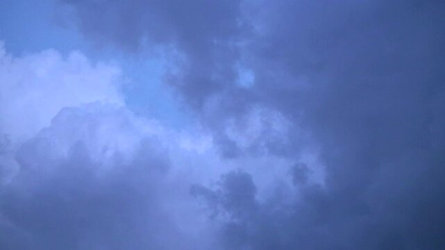 Overcast sky with dark clouds and patch of lighter blue sky