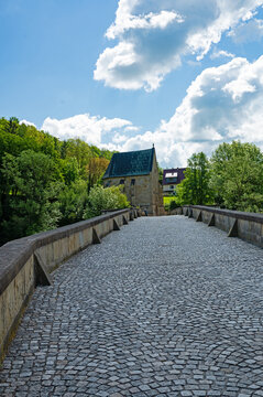old stone bridge over the river Werra and liborius chapel near Creuzburg in Thuringia in Germany