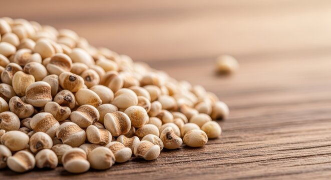 Close up macro shot of nutritious pearl millet grains piled high on a rustic wooden table, emphasizing healthy, gluten free whole food ingredients, dry, vegetarian, raw