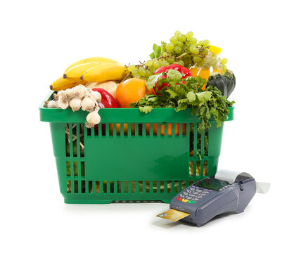 Shopping basket full of food with payment terminal and credit card isolated on white background