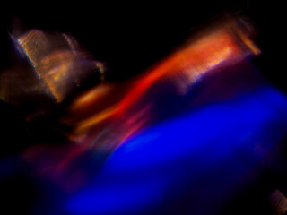 Fototapeta premium Blue glow pulses softly against dark void. Light swirls in organic, abstract motion. Faint hints of form suggest hidden energy. Perfect for futuristic or mysterious themes
