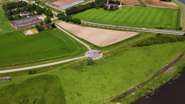 Aerial orbiting shot of a monument on a dutch dike
