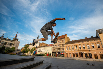 Skater performing trick in urban city plaza © Zoran Jesic