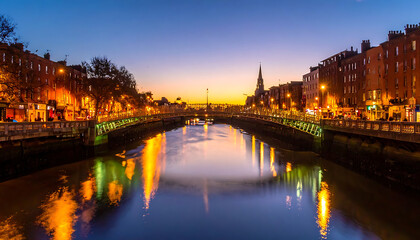 Fototapeta premium City canal at dusk reflecting glowing lights from buildings and bridges, serene evening atmosphere, Dublin Ireland