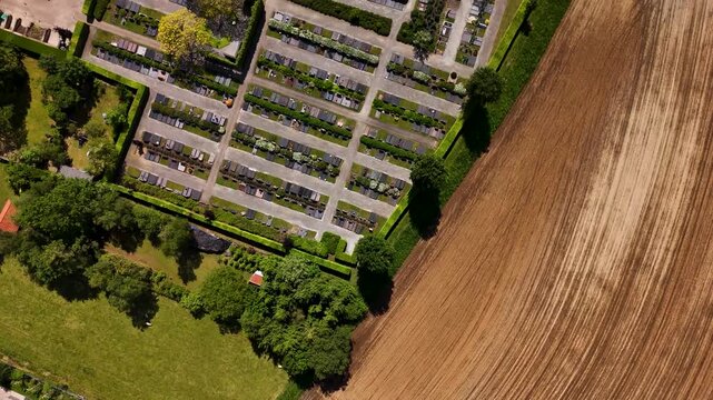 Aerial view of a cemetery with rows of graves and tombstones