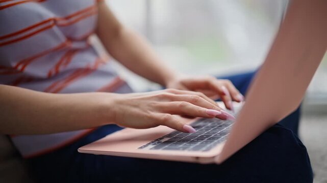 Manicured hands typing computer making online research home. Freelancer working