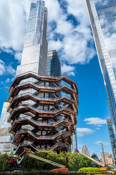 New york, usa august 20,2024. The vessel structure rising against a clear blue sky, surrounded by modern skyscrapers in new york city's hudson yards neighborhood