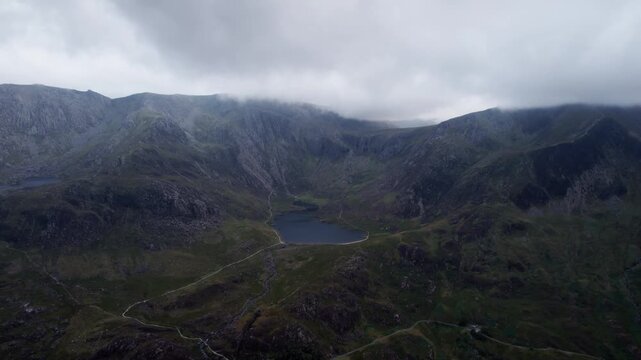 Glacial Mountain Lake Beneath Storm Clouds in Snowdonia