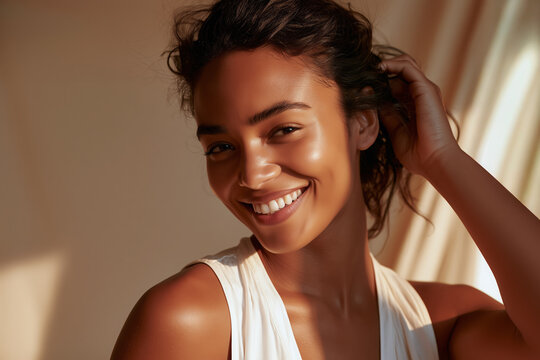 A close-up photo of a beautiful Brazilian model smiling and applying beauty cream to her beautiful skin. For advertising of skin care, cosmetics and beauty care