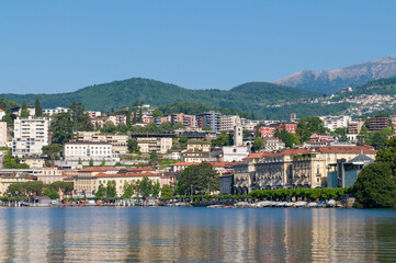 Fototapeta premium Lugano city skyline waterfront on lake Ceresio with mountain landscape background Ticino Switzerland