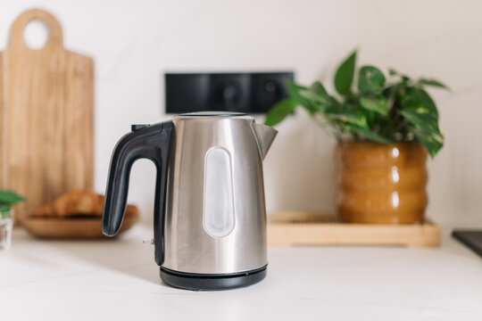 Modern kitchen interior with a stainless steel electric kettle