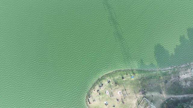 . Using a drone, the top-down view beautifully captures various people enjoying the serene environment of Deepor Beel,of Assam, highlighting its natural charm and peaceful ambiance.4k