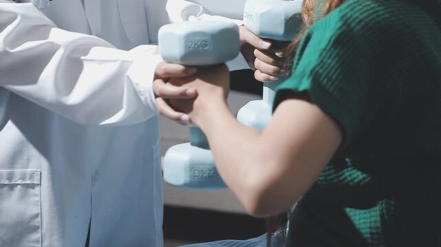 doctor is checking for muscle injuries and using dumbbells test injury and also help with physical therapy strengthen muscles because physical therapy will help strengthen muscles and help blood flow