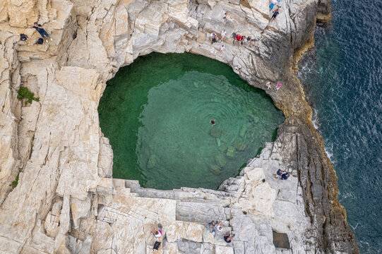 Giola lagoon natural pool aerial view with tourists swimming
