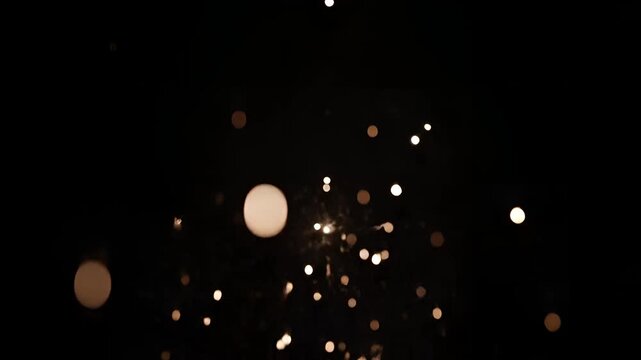 Sparkler fireworks exploding in the dark night sky.