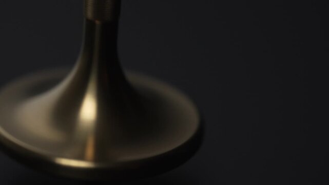 Gyroscopic Precession Close-Up Golden Spinning Top Motion on Black Background