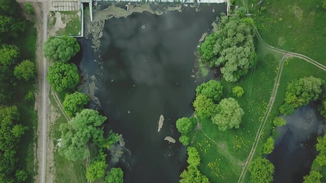 Forward drone flight above dam with upward tilt