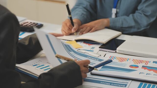 Auditor and accountant working in office Analyze financial data and accounting records with a calculator. Accounting companies provide financial and tax planning services. Close-up pictures