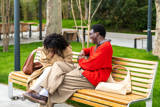 Cheerful african american couple man and woman joking and laughing together while spending time on date, happy black male and female friends sharing positivity and pleasure, healthy relationships.