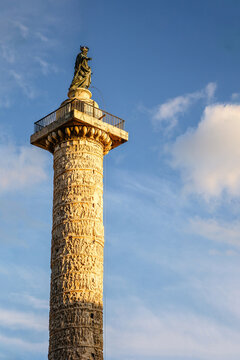 Column of Marcus Aurelius. Ancient column with statue in Rome city square under blue sky, Italy 