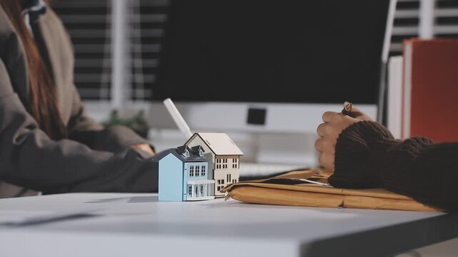 The real estate agent closes the deal with the client and they sign the contract.