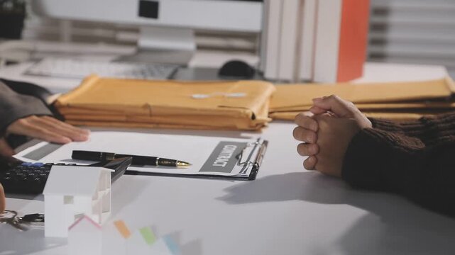 The real estate agent closes the deal with the client and they sign the contract.