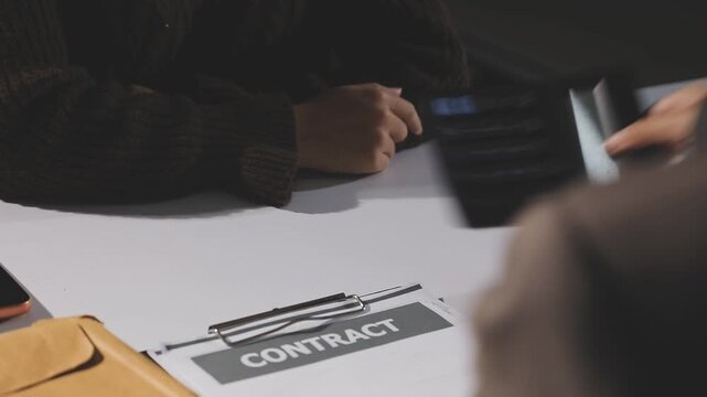 The real estate agent closes the deal with the client and they sign the contract.