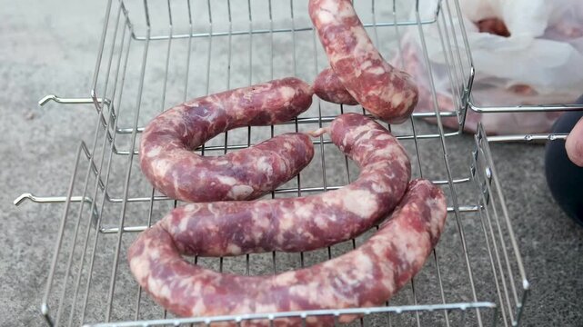 Close up of uncooked raw sausage showcasing its juicy texture, ideal for flavorful dishes and culinary creativity. black background. top view. High quality 4k footage