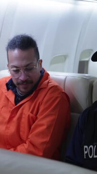 Police transporting an inmate on a private jet