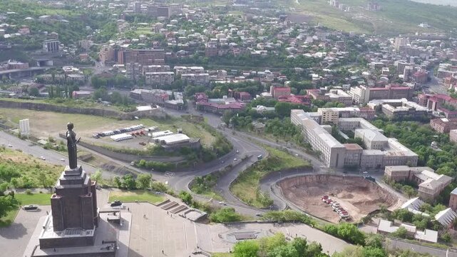 Aerial view of the Mother Armenia monument in Yerevan, featuring a military ceremony at the base of this giant statue on a bright sunny day in late spring.

