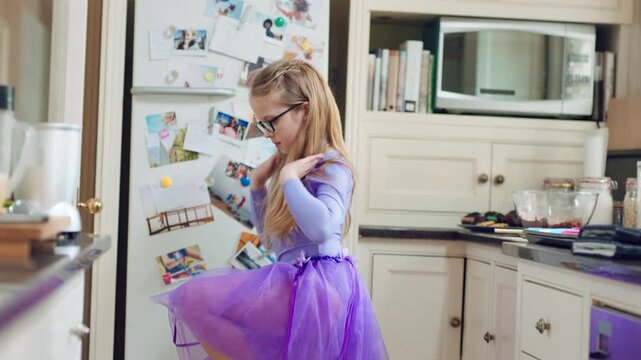 Creative, dance and child with ballet in home for recital practice, flexible movement or growth. Girl kid, ballerina or routine with tutu in kitchen for learning steps, physical development or skill