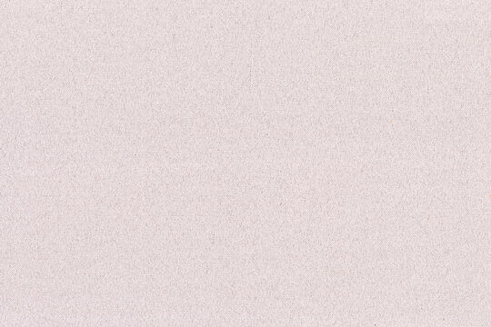 Light beige textured fabric background with a soft, woven style