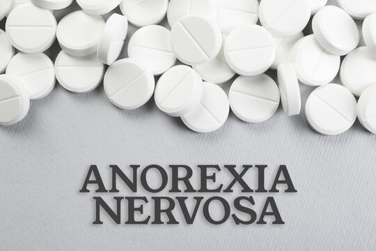 Anorexia concept. Many pills on light background, top view