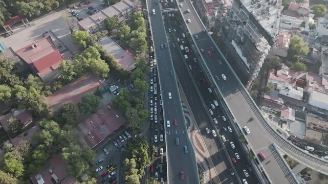 Aerial panoramic view of highway traffic on Periferico Sur and urban sprawl in southern Mexico City