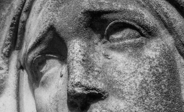 Close up of the Virgin Mary statue with tears and sorrowful expression.