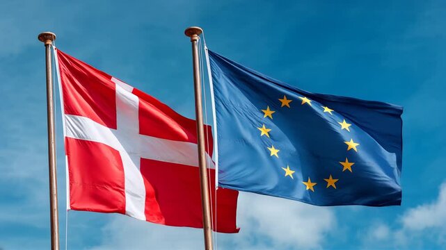danish flag waving next to eu flag in blue sky. denmark european union member