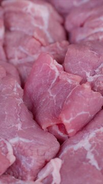 Brightly illuminated image showcasing fresh meat with textured marbling. Highquality photographic depiction of fresh meat arranged on tray emphasizing marbling details