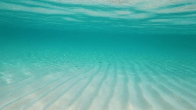 Cinematic Split View Half Underwater Turquoise Ocean with Sandy Bottom and Sky Horizon in Slow Motion Loop
