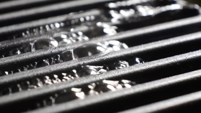 Close up of water droplets on metal grill bars abstract background.