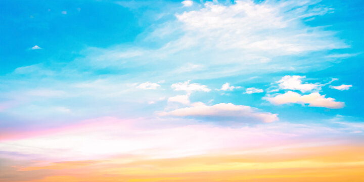 Beautiful vibrant cyan blue sky background with colorful pastel pink and golden orange clouds at sunset for inspirational nature wallpaper panorama