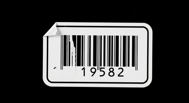 Damaged barcode sticker with torn edge black and white design numerical code 19582 isolated on dark background minimalist concept retail and product identification