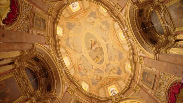 Upward view of church dome with slow rotational camera movement inside historic church in Mdina Malta