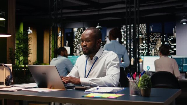 African american businessman in office doing research on laptop, planning new investment project. Entrepreneur working to increase company profit, using notebook to build development strategy.