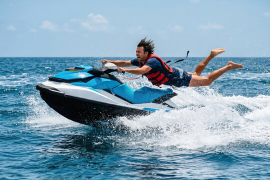Man losing control and flying off a jet ski in the middle of the ocean