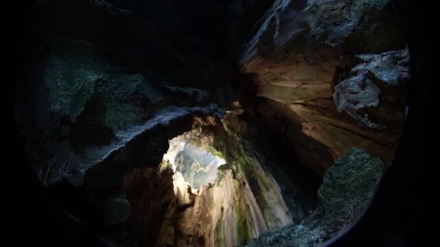 Sunlight falls through a skylight into Cathedral Cave found in Pinisil Island, Philippines. This beautiful geologic marvel is a famous tourist attraction near El Nido, Palawan.