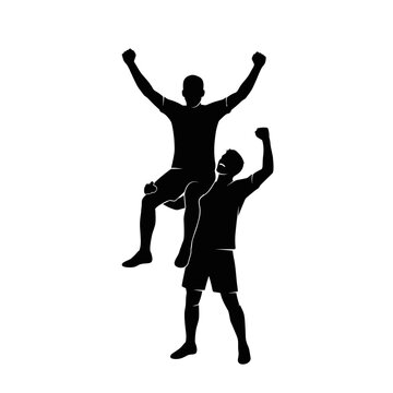 Silhouette of two soccer players celebrating a goal victory