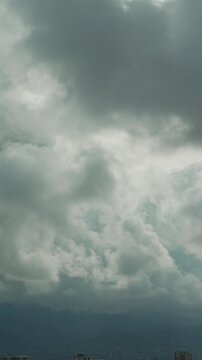 Problem of urban air pollution vertical video. Storm warning, climate change, environmental protection. Timelapse of clouds sky are scudding over mountains