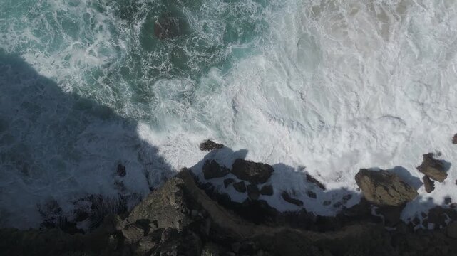 Top View of Turquoise Waves and Coastal Rocks