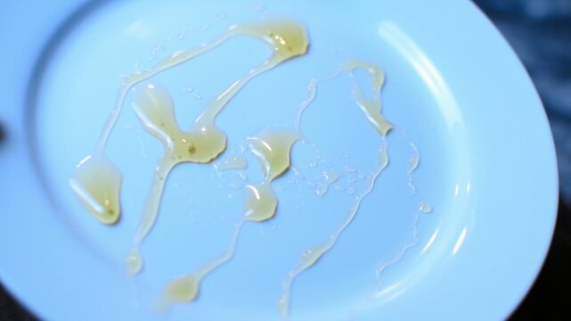 Sweet golden honey on a white saucer. 